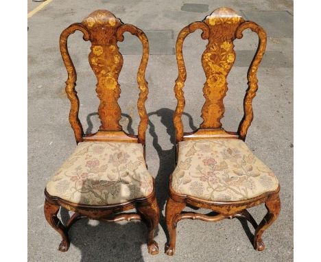 A pair of 18th century Dutch walnut and marquetry high back dining chairs, the inlaid splat depicting a bird above a flower-f