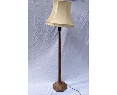 Robert 'Mouseman' Thompson of Kilburn (1876-1955), an oak standard lamp of faceted tapered form, on an octagonal base, with s