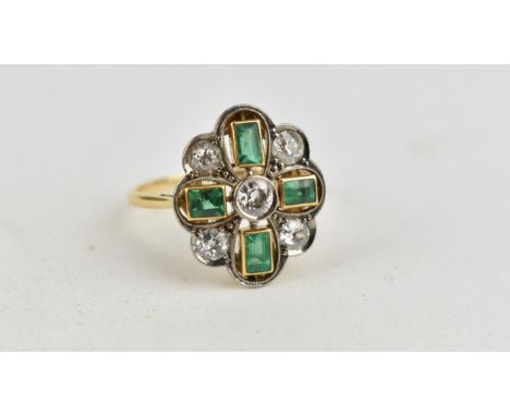 An 18ct gold and platinum Art Deco style ring set with a central diamond within alternating diamonds and emeralds, approximat