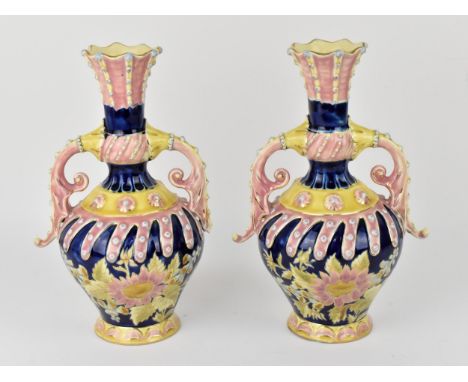 A pair of late 19th century Zsolnay Pecs glazed ceramic pair of ewers, in the Turkish style with twin scroll handles and flar