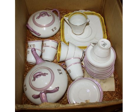 An Edwardian French porcelain part tea service, white with pink lustre handles and borders, gilt initials, including teapot a