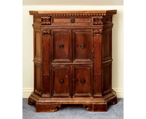 A small floor standing North European fruitwood cabinet, probably late 18th century, of canted form, the plain top over a thu