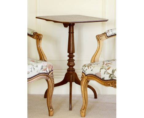 A George III mahogany tripod table, the slim, rectangular top with clipped corners, over a turned and tapered stem on downswe
