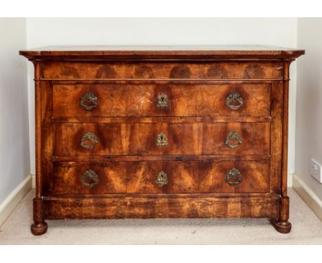 A French early 19th century fruitwood commode, of three graduated drawers, with cast brass handles of half lions and foliage 