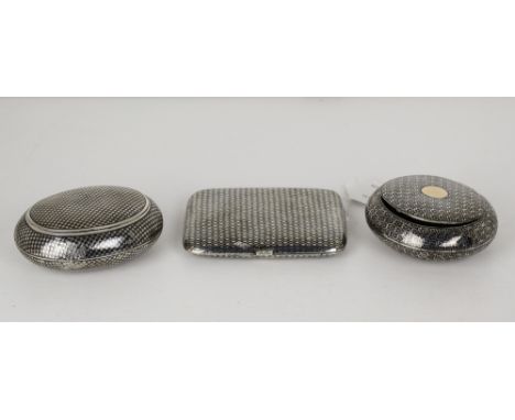 Two French oval niello silver snuff boxes, one with star design, 3½ x 2¾in. (9 x 7cm.), the second with quatrefoil within cha