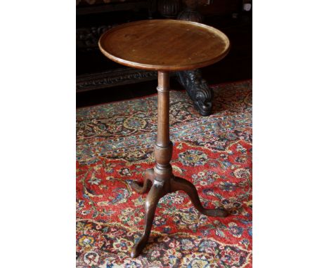 A mahogany topped tripod wine table, part 18th century, the boxwood strung top and raised moulded edge, on a late 18th centur