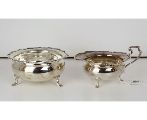 An Elizabeth II silver sugar basin & cream jug, Atkin Bros., Sheffield 1956, with shaped, flattened rims and rounded, raised 