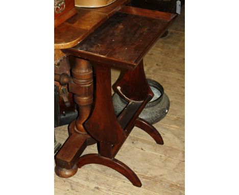 A 1920s walnut book trough table, 