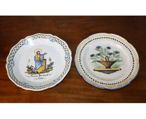 Two 19th century Quimper plates, one marked 'FB', painted with a saint and 'Pierre Bernard, 1787', within a diaper and floral