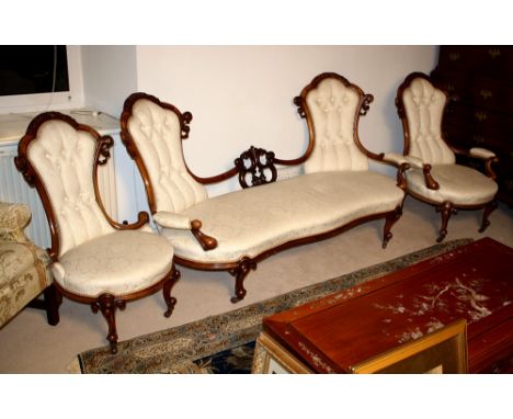 A fine quality Victorian carved walnut three piece drawing room suite, comprising a double ended button back settee and a gen