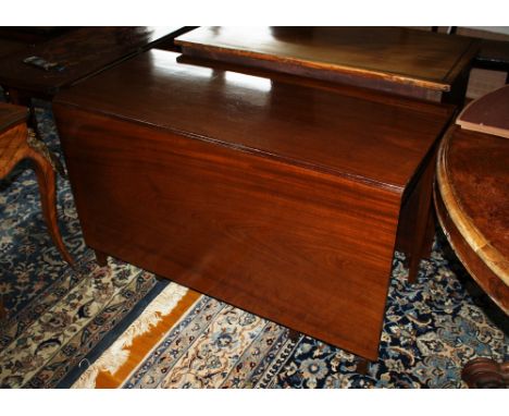 A George III 'cottage' mahogany dropflap dining table, circa 1800, the deep drop-leaves over eight square section tapered leg