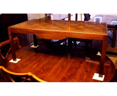 A mahogany and oak trellis pattern parquetry coffee table, late 20th century, the caddy moulded edge over a shaped skirt and 