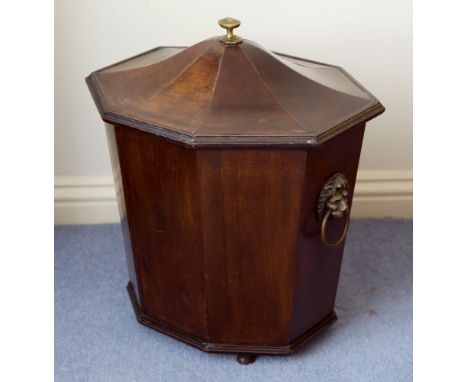 A Georgian mahogany tapered octagonal cellarette, the faceted, serpentine domed lid with caddy moulded edge, over the sides w