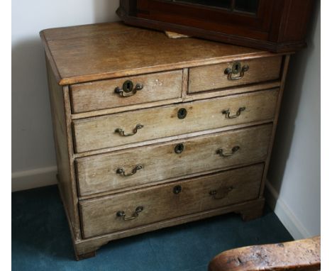 A George III oak chest of drawers, of small proportions, old stripped finish, the moulded top over two short and three long g