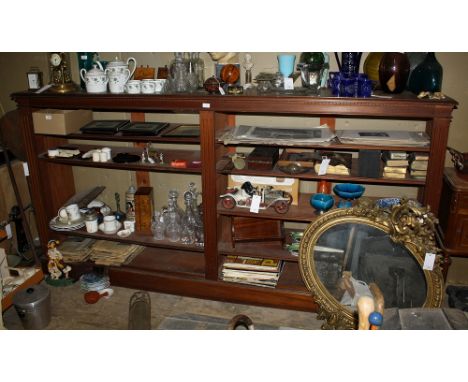 A large late 19th century mahogany set of open bookshelves, the caddy-moulded top with dentil frieze above the centrally divi