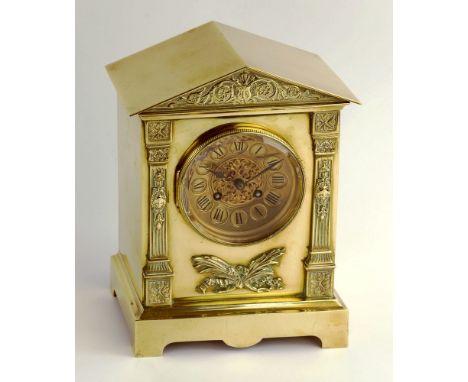 A French 19th century brass mantel clock by Mart and Cie, the apexed roof case with embossed floral and scroll pediment, conc
