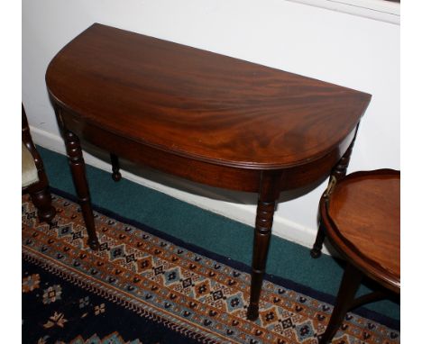An early 19th century D-shaped mahogany side table, converted from a card table, the reeded top with ebony stringing, raised 