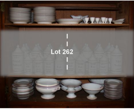 A French 19th century porcelain part dinner service, with pink lined borders, monogrammed, including tureens, serving platter