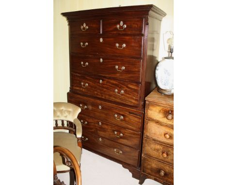 A George III mahogany chest on chest, the flared cornice over two short and three long graduated oak lined drawers with later
