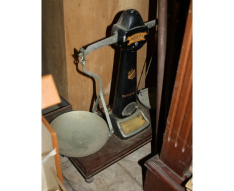 A set of mahogany based shop scales by H. Pooley & Sons, the base 17¾ x 8½in. (45 x 21cm.), the scales 18½in. (47cm.) high.