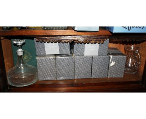 Fourteen boxed Dartington cut glass whisky tumblers, together with a Dartington style plain glass ship's decanter. (8)