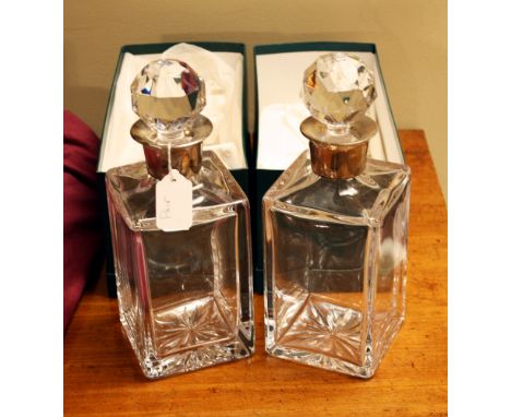 A pair of silver mounted square glass decanters, Albert Edward Jones, Birmingham 1990, plain square form with star cut bases 