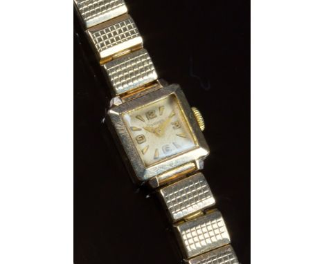A vintage Longines 9ct gold ladies wrist watch, hallmarked Birmingham 1957, the 10mm. square silvered dial with Arabic numera