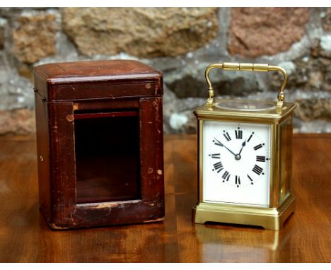 A French gilt brass half hour striking carriage clock, early 20th century, in squat Corniche case, white enamel Roman dial, b