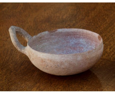 A Greek Corinthian Terracotta dipping cup, deep bowl with a single triangular ovoid shaped upturned handle, 5½w x 2h in. (14 