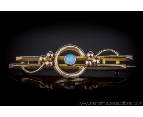 An antique 9ct rose gold and opal bar brooch, Art Deco period, 1920s, the single, circular cabochon opal centred on a double 