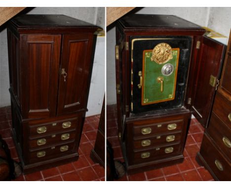 An Edwardian mahogany safe cabinet by the Milner Safe Co., the caddy moulded top over two single panel doors, opening to reve