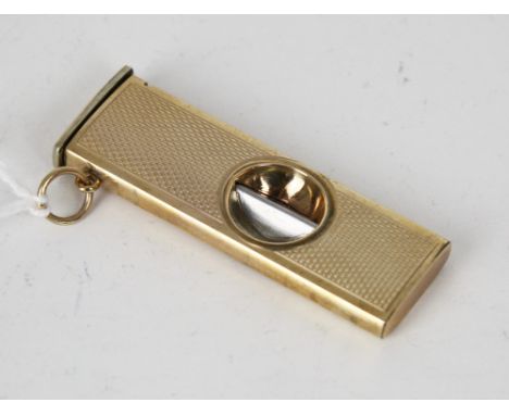 A 9ct gold cigar cutter, W.M.LD., Birmingham 1997, rectangular with engine turned decoration, 2 1/8in. (5.4cm.) long., * Cond