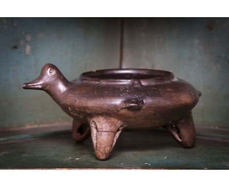 A pre-Columbian style glazed grey pottery anthropomorphic vessel, with thick, dark grey-brown glaze, the circular, counter fo