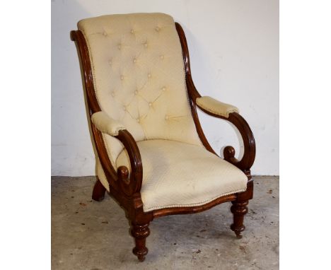 A Victorian rosewood button back armchair, with serpentine seat, the half padded arms with crook supports on turned inverted 