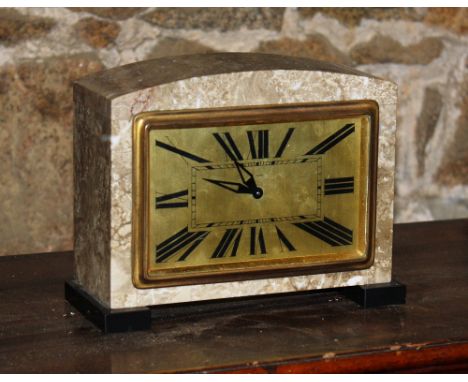 A French Art Deco marble mantel clock, 1920s, mottled beige marble on black platform feet, the rectangular gilded dial with R