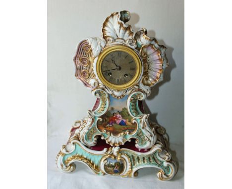 A porcelain mantel clock, the brass dial within a 'keyhole' shaped rococo case with a purple and pale blue ground and gilded 