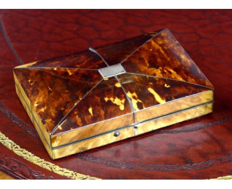 An early 19th century tortoiseshell veneered jewellery box, oblong form with slightly domed lid and applied silver plaque, un