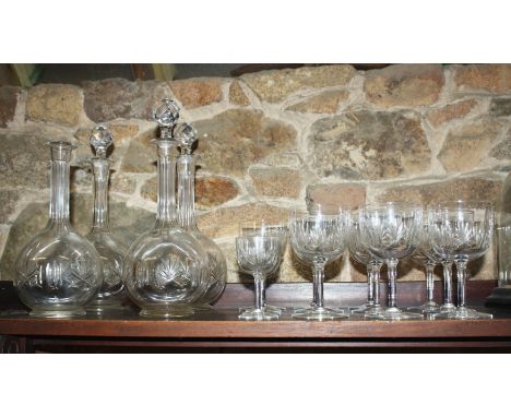 A set of four cut glass globe decanters, second quarter 20th century, comprising two pairs of different sizes, with foliate s