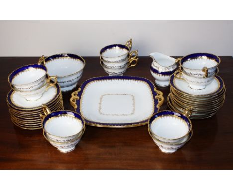 A Coalport part tea service, comprising two rounded square bread and butter plates, eleven tea cups, twenty-three saucers, a 