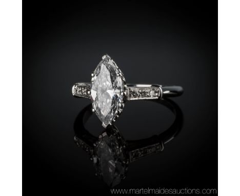 An 18ct white gold and diamond ring, with central marquis cut diamond, approx. 2.5 carats, each shoulder set with three small