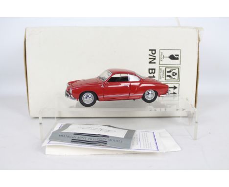 Franklin Mint - A boxed Franklin Mint diecast 1:24 scale 1967 Volkswagen Karmann Ghia. The model in red appears to be in Very