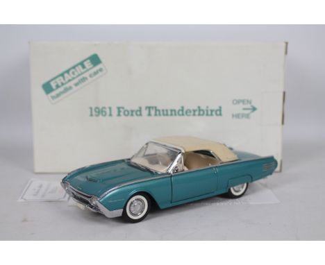 Danbury Mint - A boxed Danbury Mint diecast 1:24 scale 1961 Ford Thunderbird. The model in green white appears to be in Very 