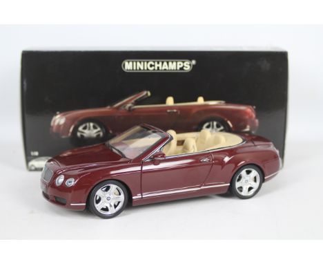 Minichamps - A boxed 1:18 scale Bentley Continental GTC 2006. The model in red metallic appears to be in Mint condition, and 