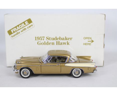 Danbury Mint - A boxed Danbury Mint diecast 1:24 scale 1957 Studebaker Golden Hawk . The model in gold and white appears to b