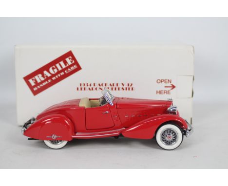 Danbury Mint - A boxed Danbury Mint diecast 1:24 scale 1934 Packard V-12 LeBaron Speedster. The model in red appears to be in