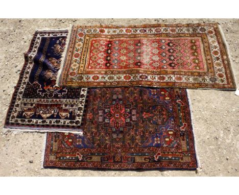 A 20TH CENTURY RUG with vibrant geometric patterns and foliage including birds and flowers together with a 20th century repro