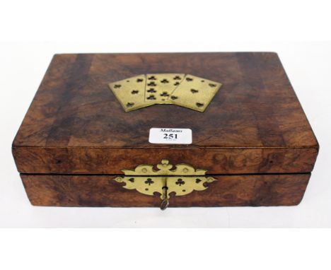 A BURR WOOD CARD GAMES BOX with brass mounts in the shape of playing cards and cards therein, 27cm x 17cm