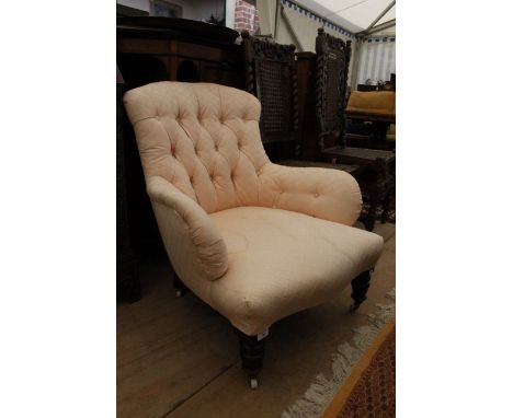 A VICTORIAN BUTTON UPHOLSTERED LOW ARMCHAIR with turned front legs, 78cm wide