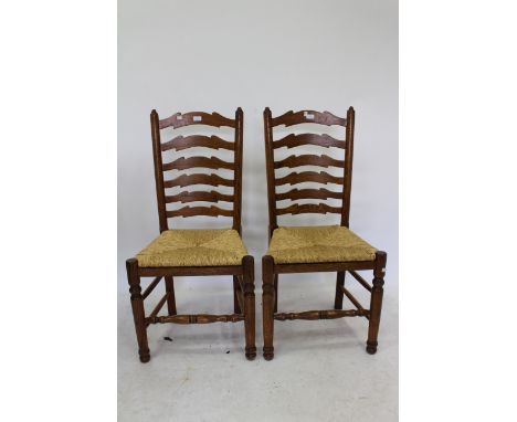A SET OF SIX MODERN LADDER BACK RUSH SEATED DINING CHAIRS