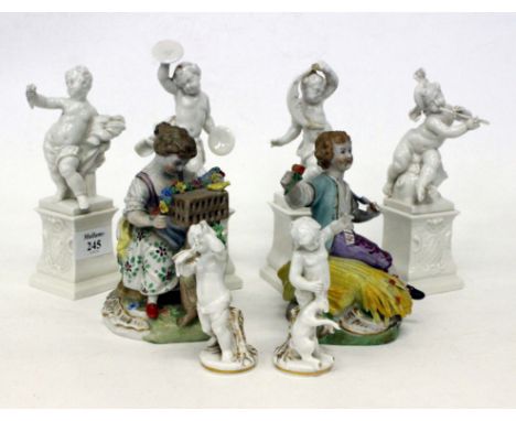 FOUR NYMPHENBURG BLANC DE CHINE FIGURES PLAYING MUSICAL INSTURMENTS, two Dresden porcelain figure groups and two Naples cheru